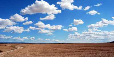 brown field and blue sky
