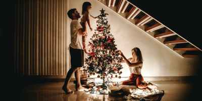 family decorating their christmas tree