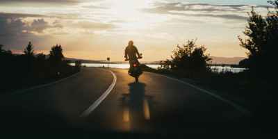 person riding motorcycle during golden hour