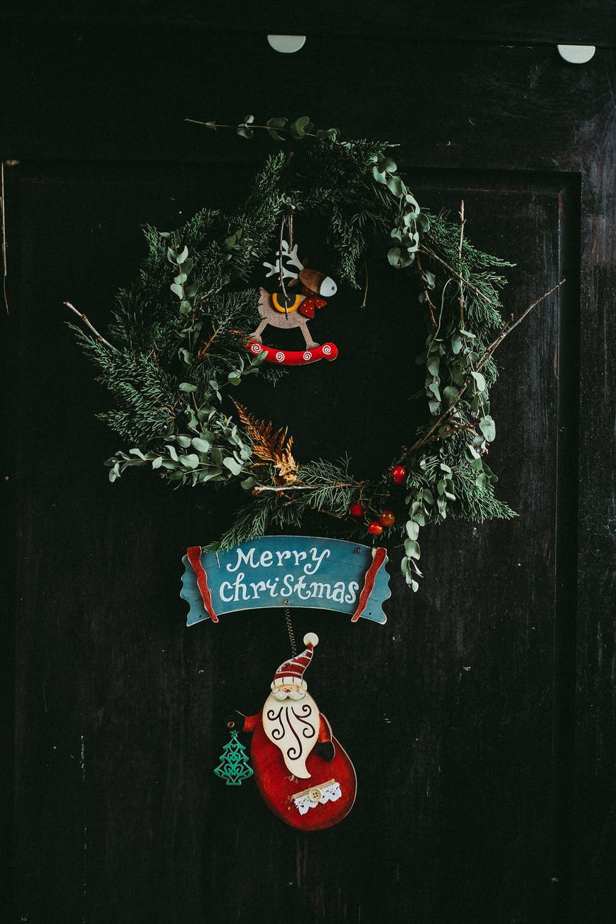 green christmas wreath hanging on door
