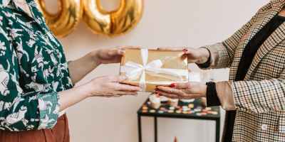 close up photo of two people holding a present