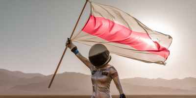 man in white and brown suit holding white and red flag