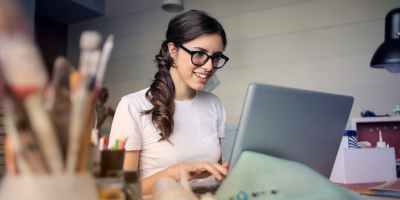 photo of woman using her laptop