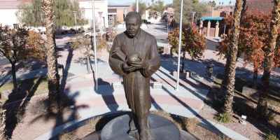 man in brown jacket statue