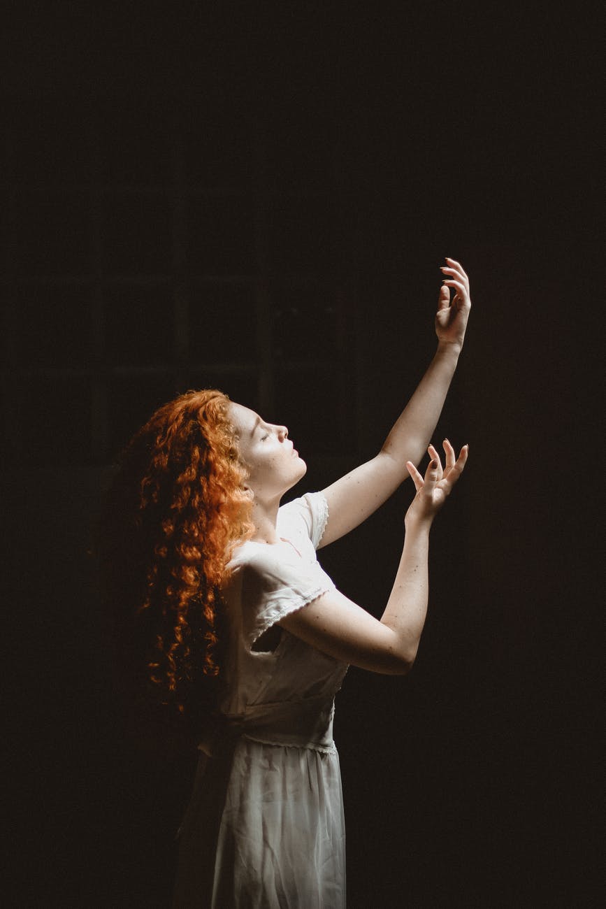 woman raising her hands