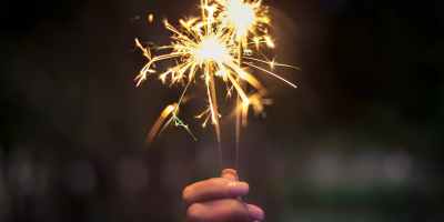 person holding lighted sparkler