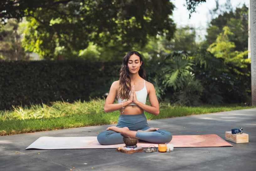 woman meditating outdoors