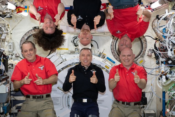 The Expedition 56 crew members pose for a fun portrait in the International Space Station's Kibo laboratory module