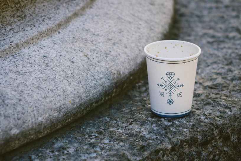 white disposable cup on concrete surface