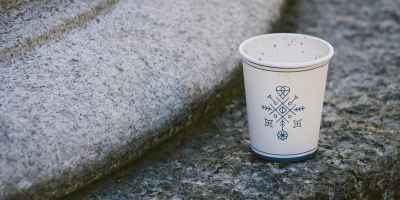 white disposable cup on concrete surface
