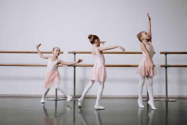girls n pink dress practicing ballet in the studio