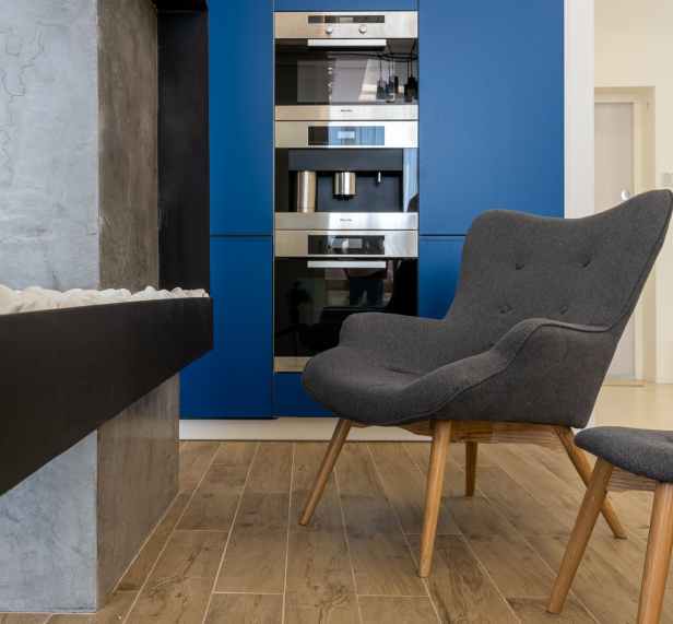 stylish armchairs in kitchen with built in appliances