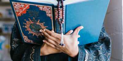 person holding blue holy book