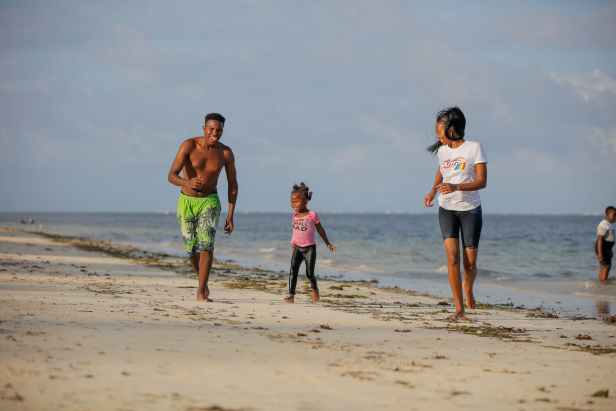 photo of people running on shore