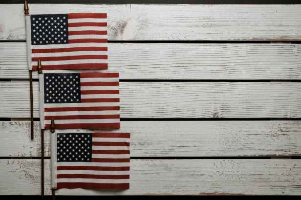 american flags on wooden surface on independence day