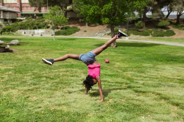 a girl breakdancing on the park