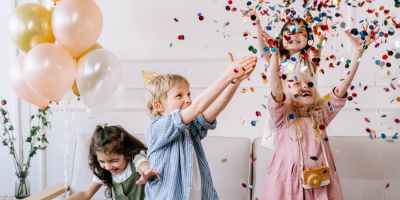 a children playing with confetti in a party